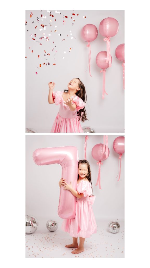 niña lanzando confeti en sesión de cumpleaños infantil en estudio en Madrid con globos rosas
